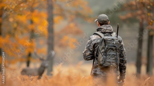 Hunter Walking Through Autumn Forest With Backpack and Rifle