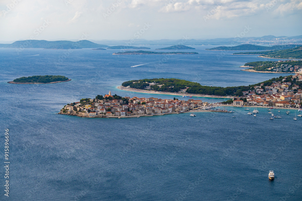 Fototapeta premium Amazing view on the small, tourist town of Primosten, Croatia built on the hill, surrounded by the sea and islands