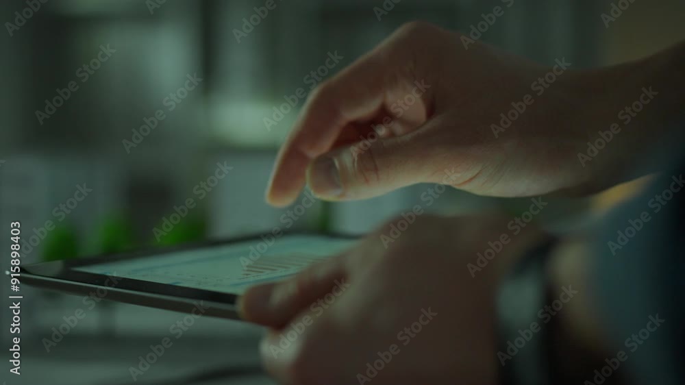 Close-up of a touch tablet. Hands of a Caucasian man control data information by touching the tablet screen. Data center worker works with electronic equipment making changes to the electronic system Close-up of a touch tablet. Hands of a Caucasian man control data information by touching the tablet screen. Data center worker works with electronic equipment making changes to the electronic system