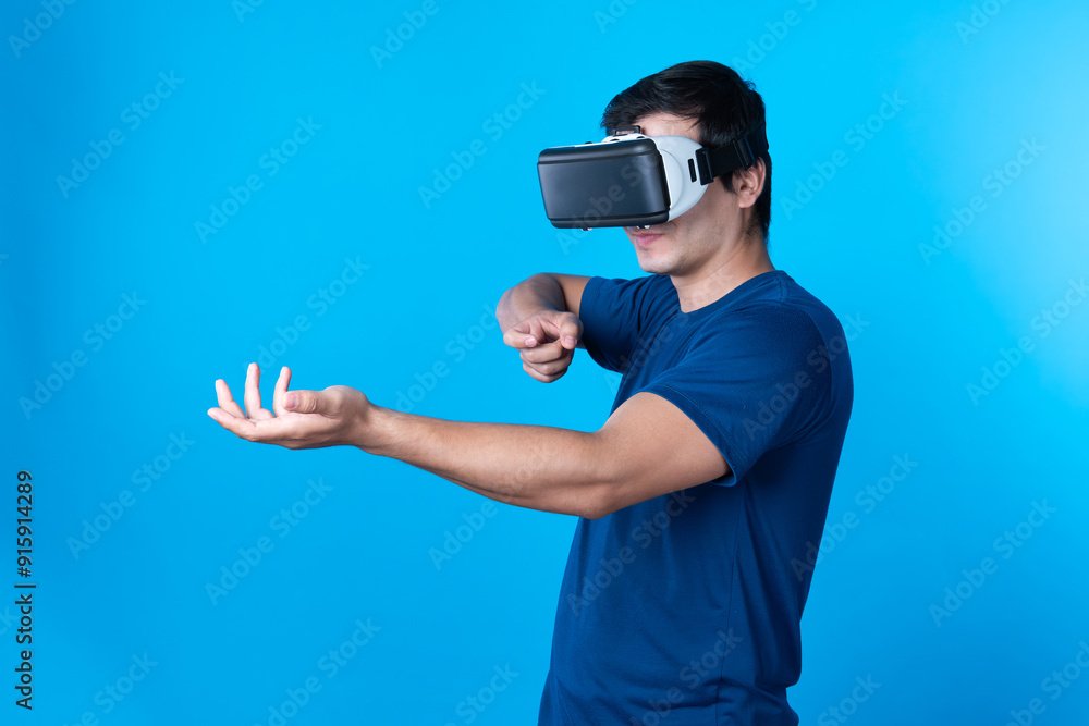 Smart gamer wearing VR turning to metaverse world playing gun shooting hunter isolated blue background connecting to victory animal hunting futuristic technology hologram virtual reality. Contrivance. Smart gamer wearing VR turning to metaverse world playing gun shooting hunter isolated blue background connecting to victory animal hunting futuristic technology hologram virtual reality. Contrivance.