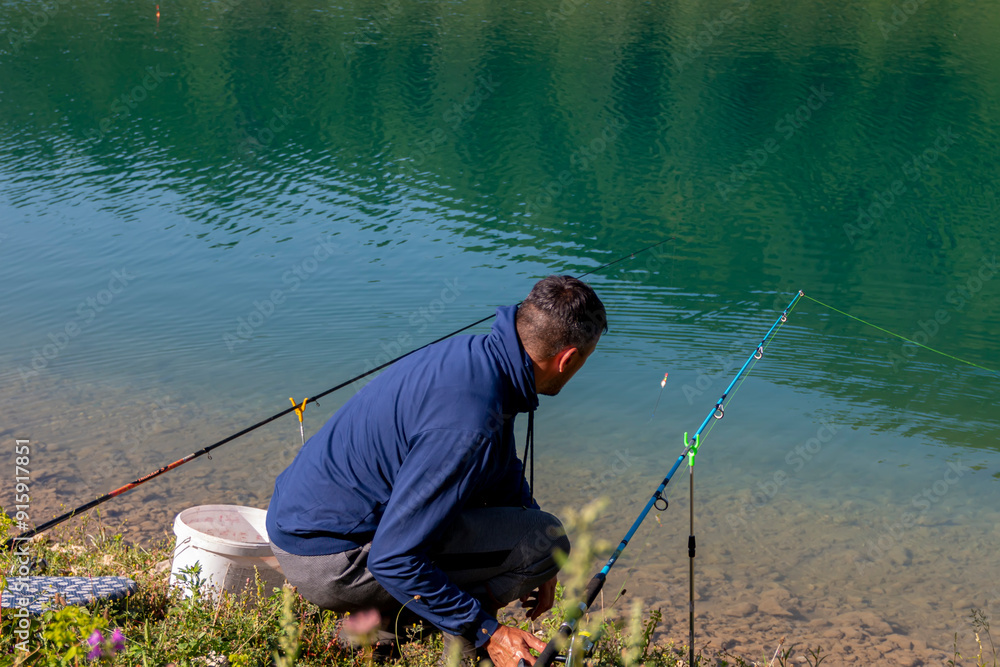 Young man fishing on the lake Young man fishing on the lake