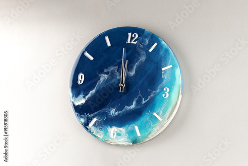 Round wall clock with ocean shore pattern. Vacation time concept. Time for rest and lunch. Luxurious epoxy resin accessories for the living room or lounge area. The concept of a minute of the Earth. photo