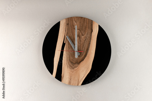 Wooden round wall clock handmade. Luxurious accessories for home, office or restaurant made of wood and epoxy in loft style. Durable eco-friendly products. photo