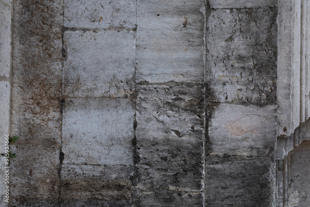 Weathered stone wall with a hint of history Weathered stone wall with a hint of history