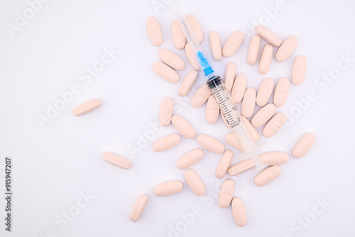 tablets and disposable syringe close-up