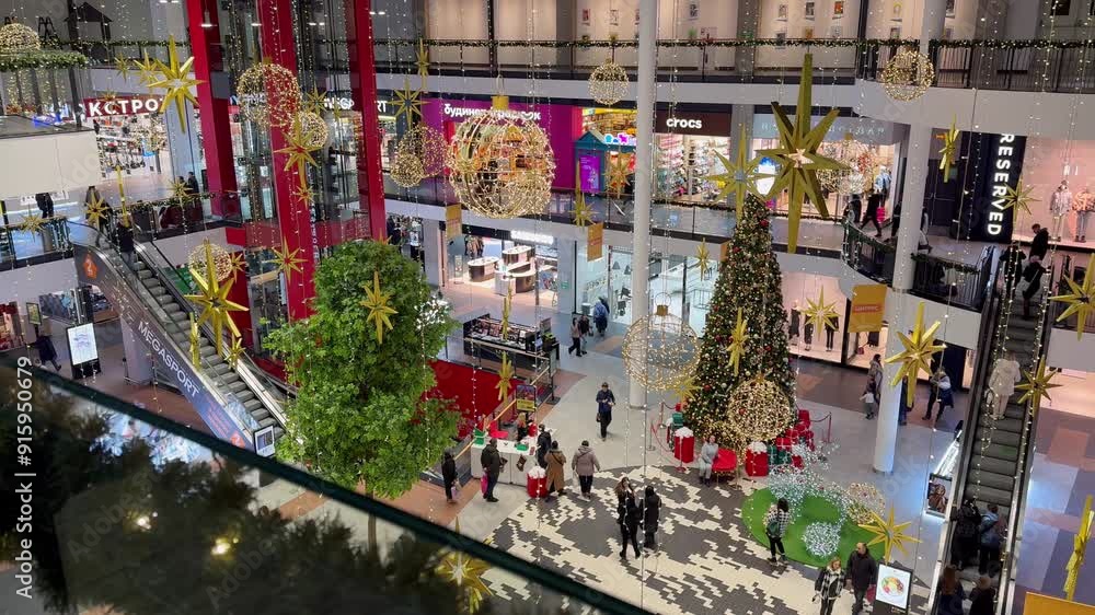 Festive shoppers in modern mall atrium with christmas decorations Festive shoppers in modern mall atrium with christmas decorations