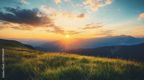 An enchanting summer vista showcasing verdant grass covering the mountainous hills, with a sunset and a cloudy sky in the background, observed through a wide-angle lens.