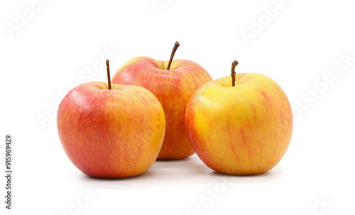 three yellow red apple white background