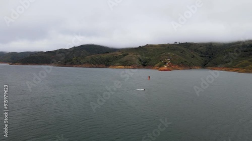 Aerial view of a person kitesurfing in lake Calima