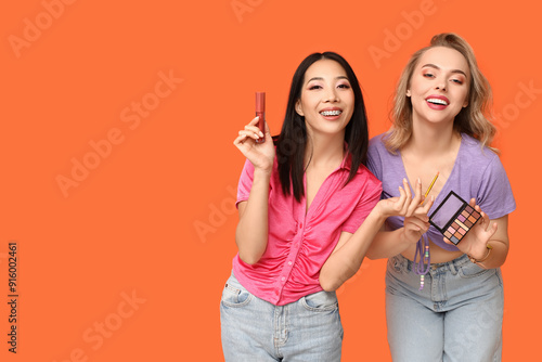 Two happy young women holdi...