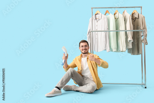 Happy young man pointing at...