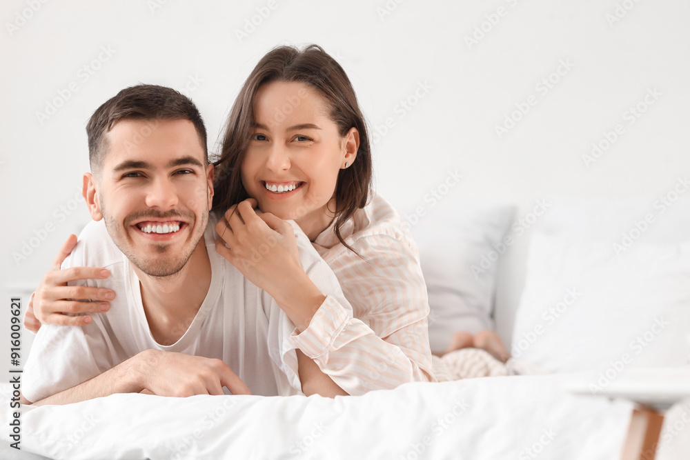 Happy young couple together in bedroom Happy young couple together in bedroom