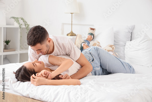 Happy young couple in bedroom