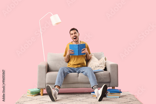 Young man reading book on s...
