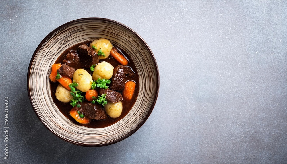 Braised venison ragout with vegetables and bread dumplings in a chocolatey red wine sauce, served in a Nordic design bowl Braised venison ragout with vegetables and bread dumplings in a chocolatey red wine sauce, served in a Nordic design bowl