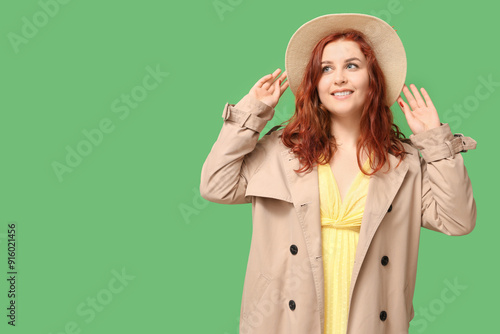 Smiling young redhead woman...