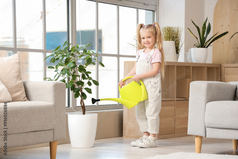 Cute little girl watering houseplant near window in living room Cute little girl watering houseplant near window in living room