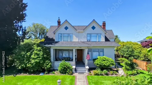 Quaint American suburban home exterior; departure drone point of view