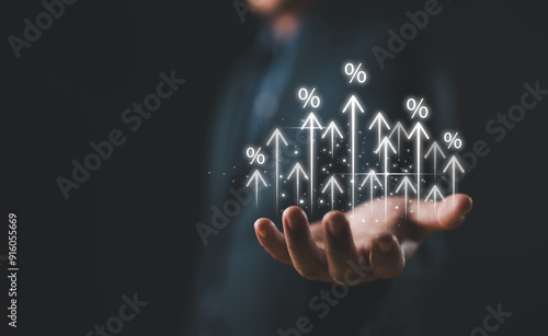 Businessman showing percentage icons and up arrow icons with graph indicators. Concept of financial interest rates and mortgage rates. Interest Rates Stocks Finance Ratings Mortgage Rates.
