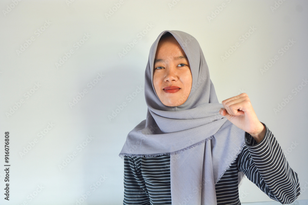 Strong woman in casual clothes smiling over isolated background showing her muscles Strong woman in casual clothes smiling over isolated background showing her muscles