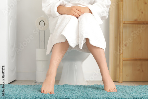 Barefoot woman sitting on t...