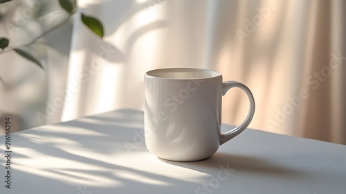 White mug on a smooth white surface, with soft morning light coming through the window