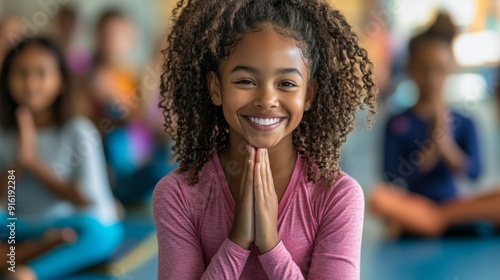 Young girl meditating in a yoga class.