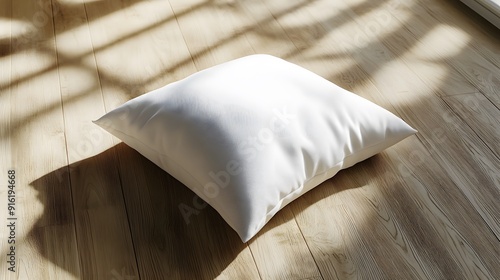 Simple white pillow mockup with a slight texture, placed on a plain wooden floor photo