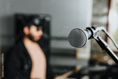 Man with glasses and hat playing electric drums. Microphone, guitar, bass. Band at home. International music day.