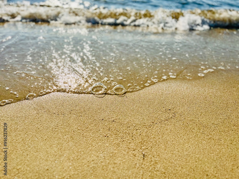 Close-up of sea surf on a sandy beach, Thassos, Aegean islands, Greece Close-up of sea surf on a sandy beach, Thassos, Aegean islands, Greece