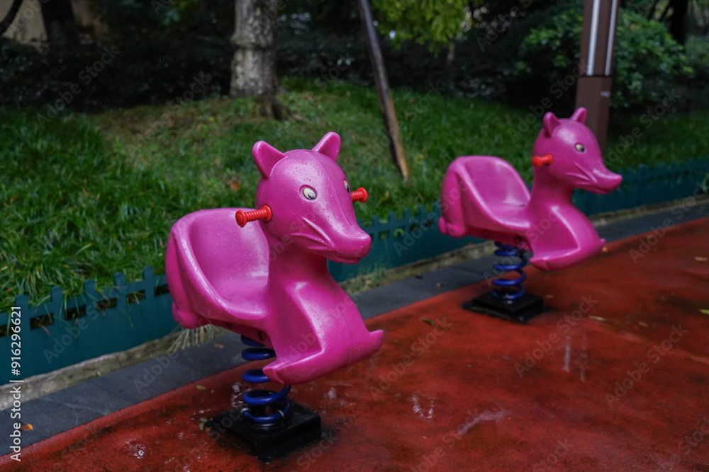 Rainy Day at Children's Playground with Pink Spring Rider