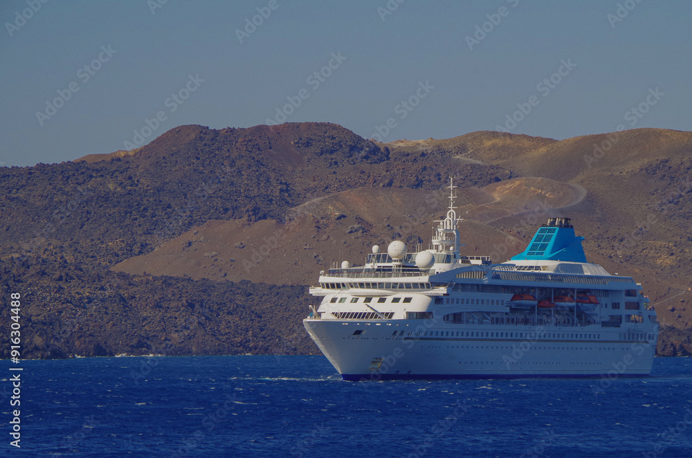 Classic cruiseship cruise ship liner Nefeli anchoring offshore of Santorini Oia Island during Summer Greek Islands aegean Greece cruising