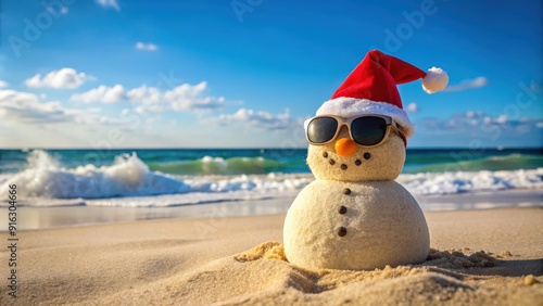 Happy sandy snowman wearing sunglasses and a Santa hat at the beach on a sunny Christmas day afternoon, sandy snowman