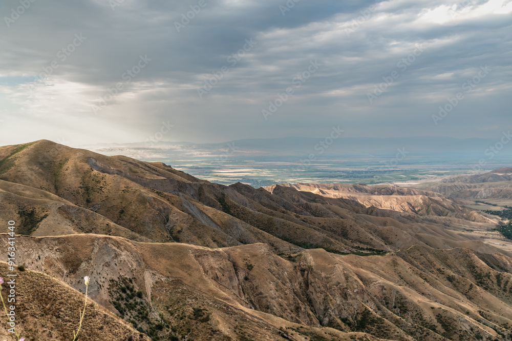 View from above of an arid mountain canyon. Mountain landscapes of Kyrgyzstan. View from above of an arid mountain canyon. Mountain landscapes of Kyrgyzstan.
