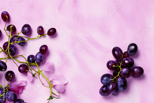 Vibrant Product Background with Fresh Purple Grapes on Soft Pink Surface for Food and Beverage Branding