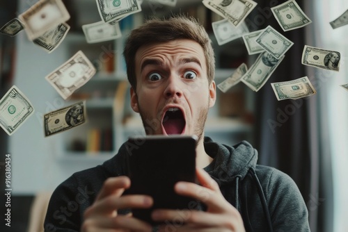 The surprise after winning the prize,Young Man Astonished by Falling Money While Using Smartphone, Capturing the Surprise and Wonder in a Tech-Savvy Financial World photo