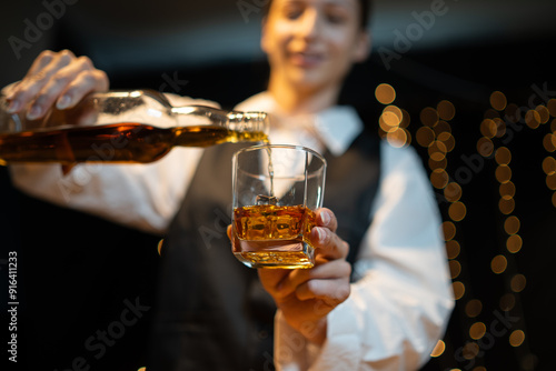 Barwoman pouring whiskey whiskey glass..