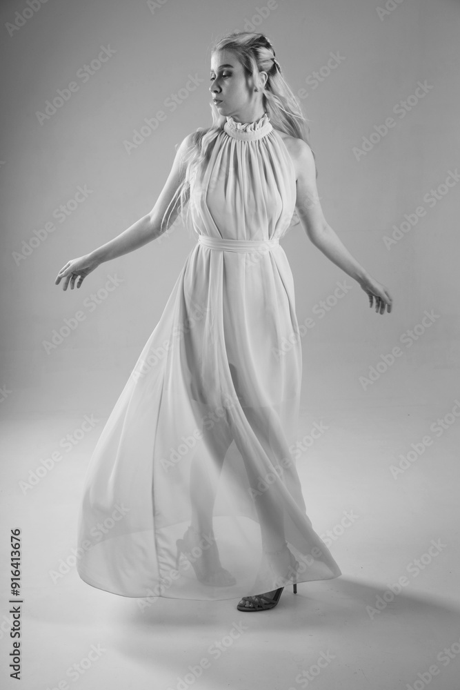 Portrait of beautiful slender woman in dress full length in black and white Portrait of beautiful slender woman in dress full length in black and white