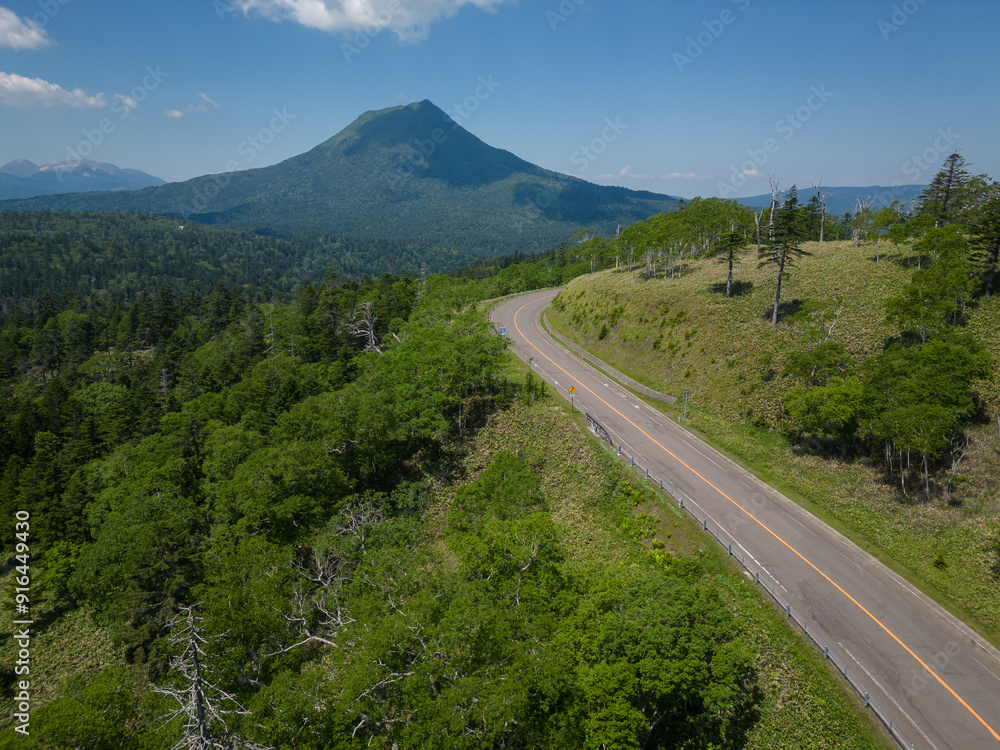 Hokkaido, Japan: Aerial view of the road in the Akan-Mashu National Park with the Mount Oakan volcano in Hokkaido in summer in Japan.