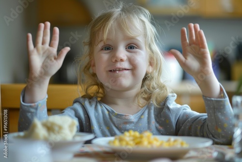 Happy dinner scene featuring child hands raised full of joy. Young boy's joyful anticipation of pasta warm indoor setting. Excitement of child's unrestrained joy and anticipation. photo