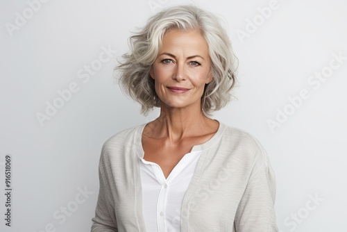 Beautiful gorgeous 50s mid aged mature woman looking at camera isolated on white.