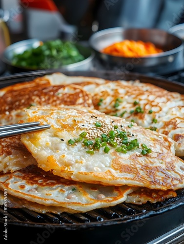 Street Food Vendor Preparing Savory Mung Bean Pancakes with Crispy Texture and Flavorful Ingredients photo