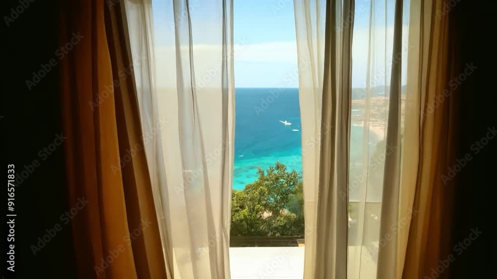 The open window of the villa offers a view of the sea. The open window of the villa offers a view of the sea.