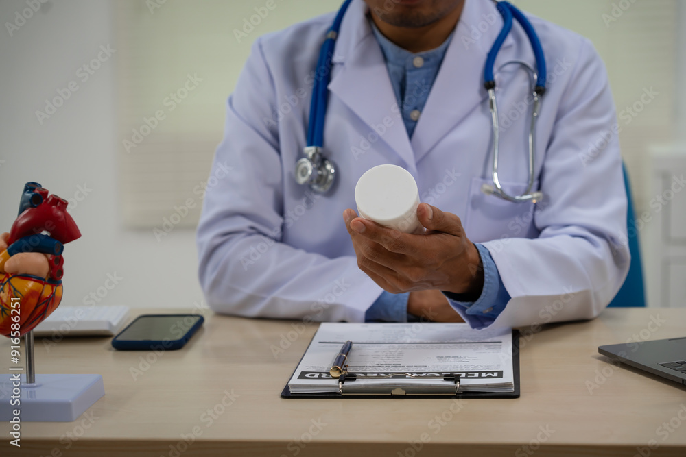 A male doctor sits at a desk in the heart clinic, consulting online and giving advice. The vascular surgery clinic offers an electrocardiogram service with modern technology and expert care. A male doctor sits at a desk in the heart clinic, consulting online and giving advice. The vascular surgery clinic offers an electrocardiogram service with modern technology and expert care.