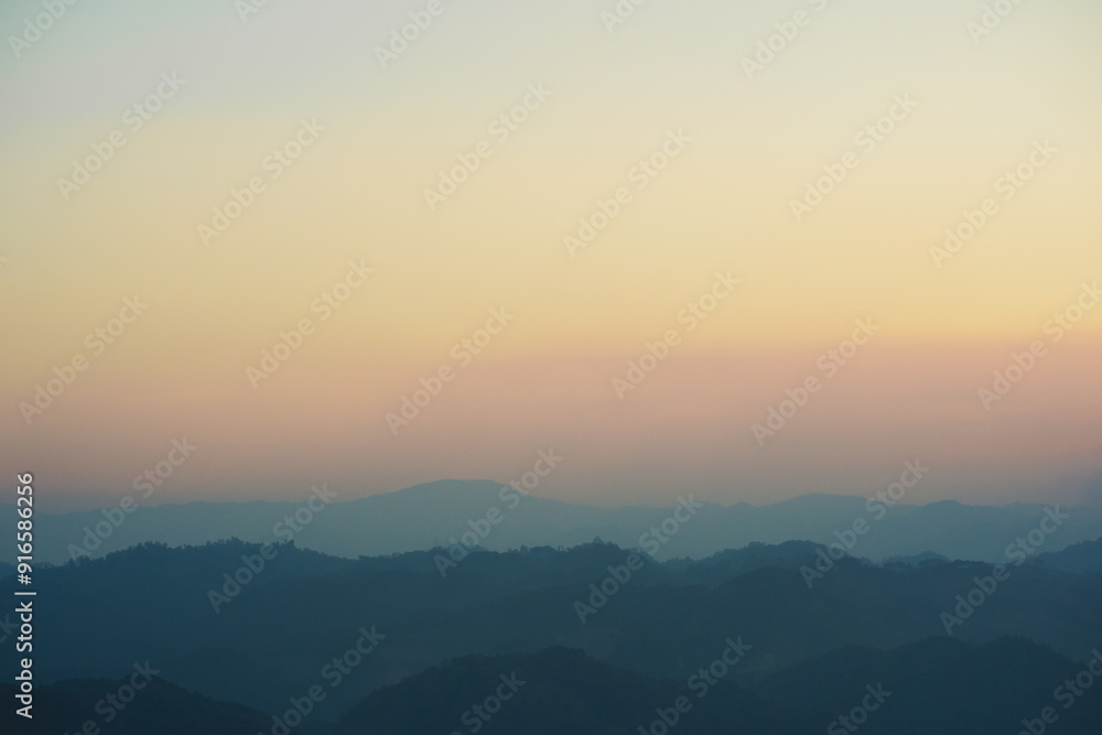 Fototapeta premium landscape and travel concept with sunset and twilight sky with layer of mountain
