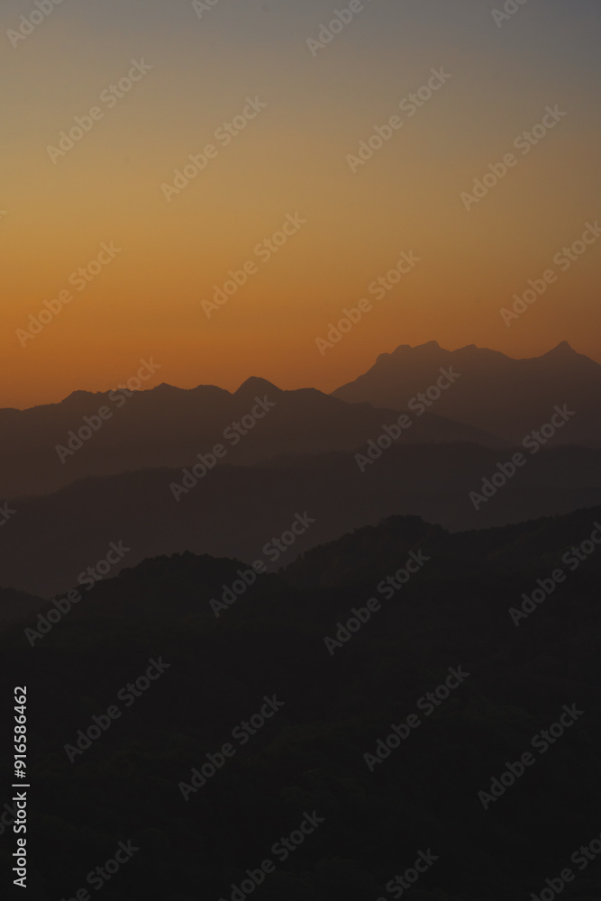 nature traveling with orange sky and layer of mountain with sunrise background nature traveling with orange sky and layer of mountain with sunrise background