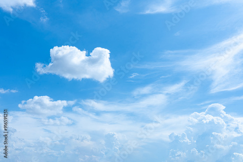 A beautiful blue sky with fluffy white clouds on a sunny day photo