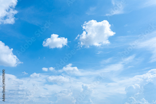 Blue sky with fluffy white clouds on a sunny day photo