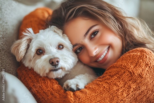 Happy Woman in Orange Sweater Cuddling Her Dog on the Sofa, Close Up Portrait Photograph in the Style of Natural Light Minimalism 