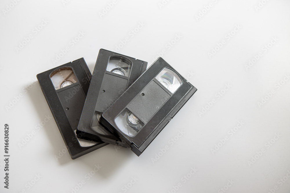 A selection of old retro video VHS tapes on a white background